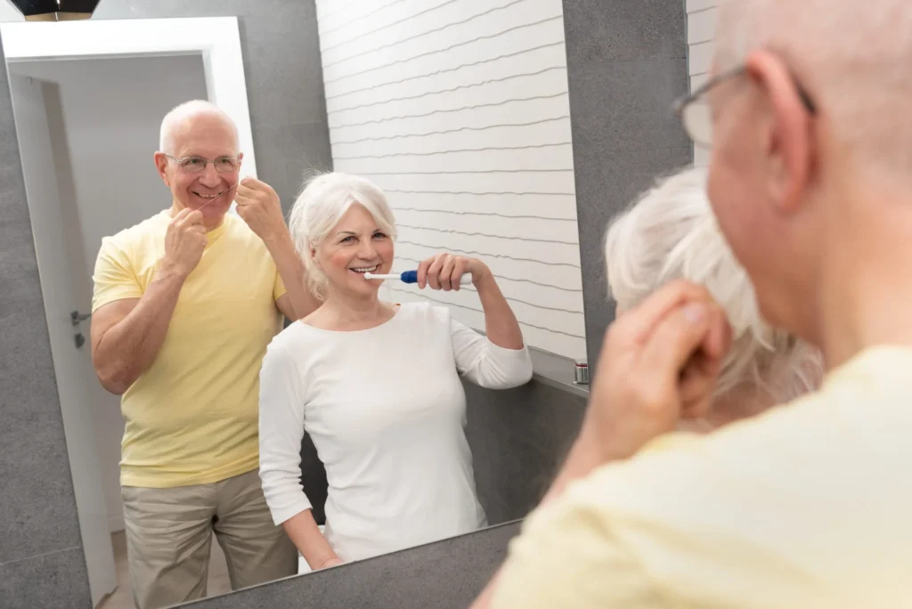 Elderly people using brushing teeth and dental floss. Morning in the bathroom in Zahnarzt Rheinfelden